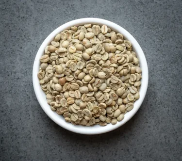 Colombia conventional green coffee beans in a white bowl