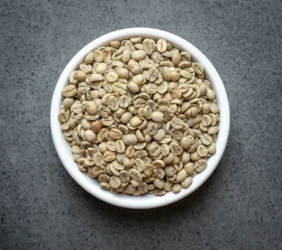 Colombia conventional green coffee beans in a white bowl