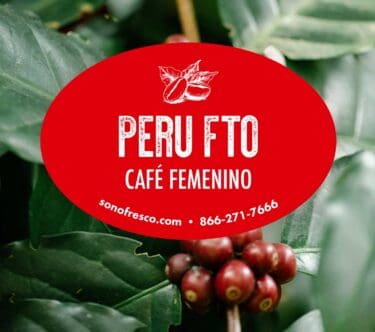 Peru FTO Café Femenino green coffee label over ripe red cherries and lush green leaves