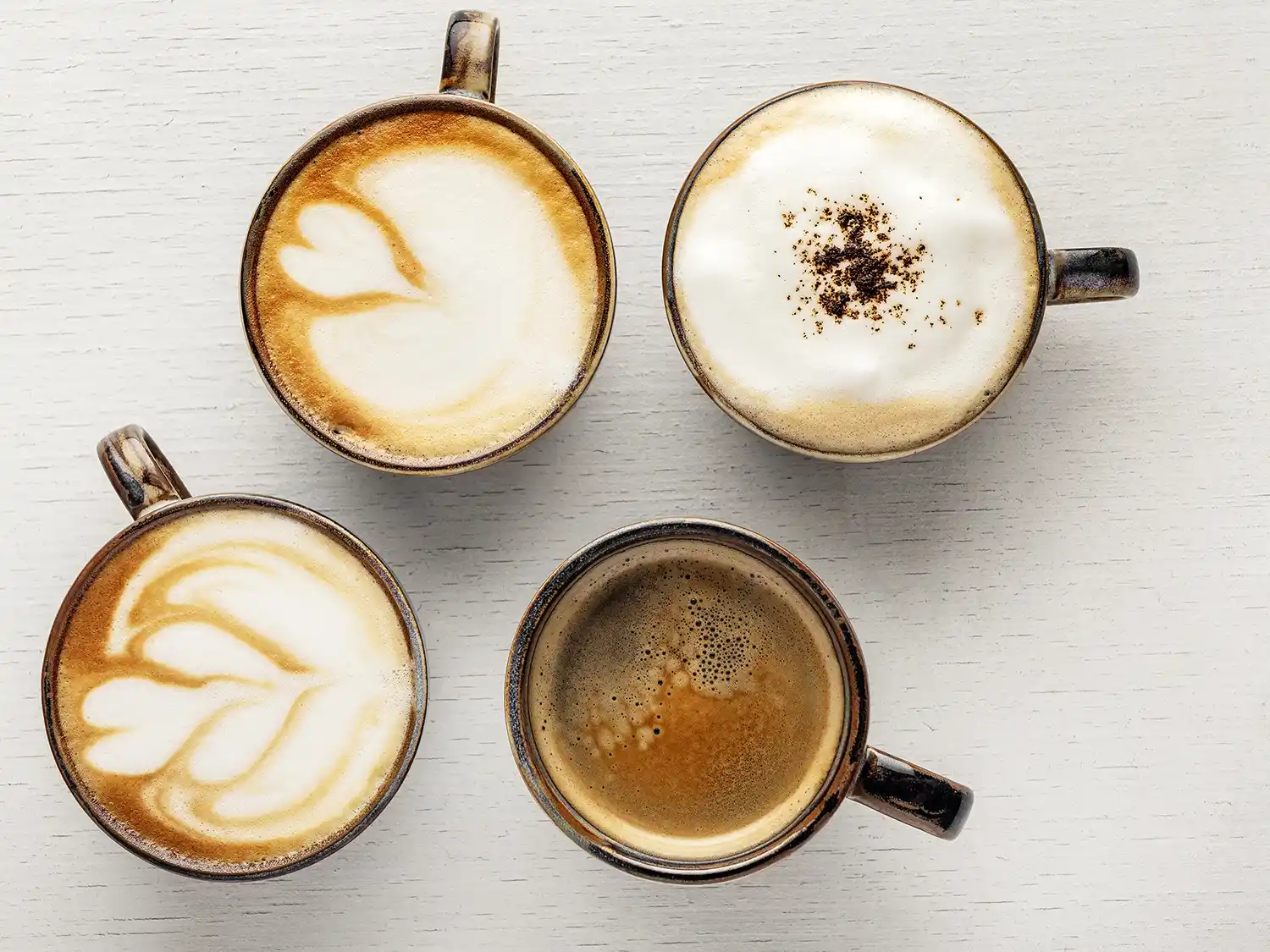 Assortment of espresso, cappuccino, latte, and other coffee drinks displayed together